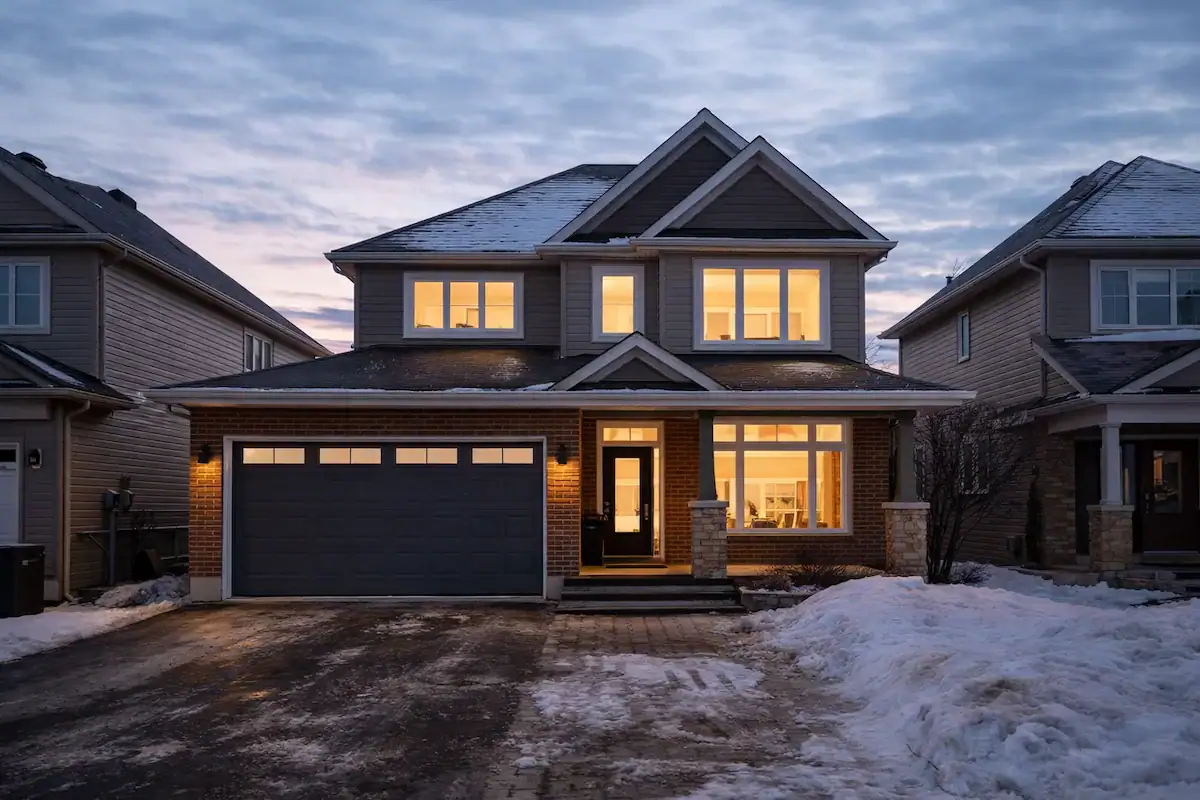 Ottawa suburban home in winter with snow-covered roof