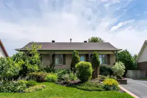 Brick veneer bungalow exterior with low-pitched roof in Ottawa suburb